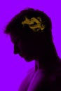 Conceptual image with silhouette of young man and pictures in his head with secrets of subconsciousness, human microcosm