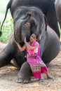 Relationship between Asian people and elephant, Thai lady beautiful dressing traditional northern style touching elephans trunk