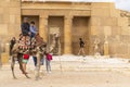 The relationship between Bedouins and tourists in the Sahara desert. Riding on dromedaries. The great pyramids of Giza.