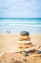 Relationship concept with pile of rocks and people in the background Royalty Free Stock Photo