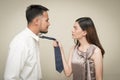 Relationship conflict trouble. Anger asian couple look at each other face to after have an argument on yellow background Royalty Free Stock Photo