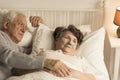 Elderly man supporting dying wife