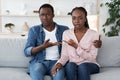 Relationship Misunderstanding. Confused Black Couple Sitting On Couch At Family Counselor`s Office Royalty Free Stock Photo