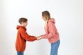 Relationship, mothers day, children and family concept - teen boy giving high five to his mom on white background Royalty Free Stock Photo