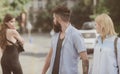 Relationship problem. Man cheating his wife or girlfriend. Bearded man looking at other girl. Hipster choosing between Royalty Free Stock Photo