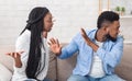 Black millennial couple arguing on sofa at home Royalty Free Stock Photo