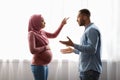 Relationship Problems During Pregnancy. Pregnant Black Muslim Couple Arguing At Home Royalty Free Stock Photo