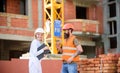 Relationships between construction clients and participants building industry. Woman engineer and brutal builder Royalty Free Stock Photo