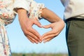 Relationships, love and old people concept - close up of senior couple showing hand heart gesture Royalty Free Stock Photo