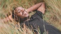 Relax african man lying on the field in beutiful meadow.Happy and enjoy nature concept