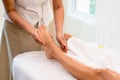 Relax with aroma oil massage in spa salon. woman lying on the bed relaxing with foot massage during treatment in beauty spa Royalty Free Stock Photo