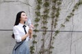 Relax Asian Chinese pretty girls wear student suit in school enjoy free time drink water in nature spring garden Royalty Free Stock Photo