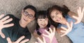 Relax Asian family laying with happy and smile on carpet in living room at home. top view