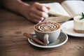 Relax Asian man drink coffee and read book in a modern style coffee shop Royalty Free Stock Photo