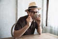 Relax Asian man drink coffee and read book in a modern style coffee shop Royalty Free Stock Photo