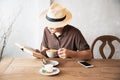 Relax Asian man drink coffee and read book in a modern style coffee shop Royalty Free Stock Photo