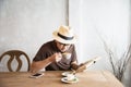 Relax Asian man drink coffee and read book in a modern style coffee shop Royalty Free Stock Photo