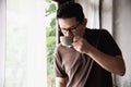 Relax Asian man drink coffee and read book in a modern style coffee shop Royalty Free Stock Photo