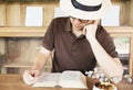 Relax Asian man drink coffee and read book in a modern style coffee shop Royalty Free Stock Photo