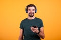 Relax attractive man with blue headphones and smartphone in his hands