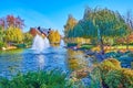 Relax in autumn park with lake and fountains