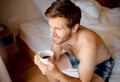 Relax, bedroom and happy drinking tea or coffee man with smile sitting, smiling and thinking on bed in the morning Royalty Free Stock Photo