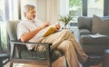 Relax, book and a senior asian man reading on a chair in the living room of his home during retirement. Study, learning Royalty Free Stock Photo