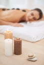 Relax, candles and woman with hot stone massage at spa for health, wellness or luxury holistic treatment. Self care Royalty Free Stock Photo