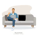 Relax Concept. Happy man drinking coffee using pc sitting on comfortable couch at home in living room . Cheerful casual male