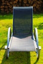 Relax. Empty deck chair on grass in garden. Royalty Free Stock Photo