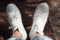 A relax feet of young woman in white sneakers background. Inspirations concept with copy space. Human body part in casual style