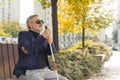 Relax in fresh air. Break from loud city at park. Autumn season. Good-looking caucasian bearded adult man with sight Royalty Free Stock Photo