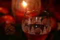 Wine glass warmed by candlelight during festive holiday season Royalty Free Stock Photo