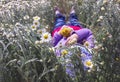 Relax girl in a field of daisies with a bouquet of flowers Royalty Free Stock Photo