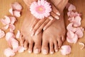 Relax, hands and feet of black woman with flower petals for luxury cosmetic treatment with manicure and pedicure nails