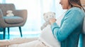 Relax, happy and pregnant woman with teddy bear in baby nursery excited for motherhood. Pregnancy belly of girl resting Royalty Free Stock Photo