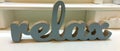 Relax - inspirational word with wooden letters at white background