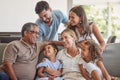 Relax, love and big family happy on sofa smile together in home on the weekend with children. Cheerful and diverse Royalty Free Stock Photo