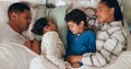 Relax, love and children sleeping with their parents in the bed for cuddling in their family house. Sweet, bonding and Royalty Free Stock Photo