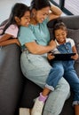 Relax, mother and streaming on tablet with children for entertainment on sofa in cozy family home. Philippines mom Royalty Free Stock Photo