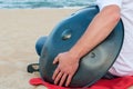 Relax music background. Hands percussion. Musician sit on sand and play the Hang or handpan. The hang is a traditional Royalty Free Stock Photo