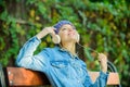 Relax in park. hipster girl relax in park with mp3 player. hipster woman in headphones relax in park. listening music Royalty Free Stock Photo