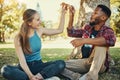 Relax, pizza and happy with couple in park for picnic, fast food and summer date. Love, youth and freedom with black man