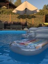 Relax by the poolside on a floating mattress in the sunset Royalty Free Stock Photo