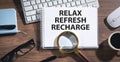 Relax, Refresh, Recharge on notepad Royalty Free Stock Photo