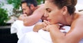 Relax, spa and couple on a massage bed with peace, calm and luxury outdoor on a zen balcony. Love, romance and woman Royalty Free Stock Photo