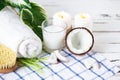Relax and spa theme. Coconut, coconut oil, milk, candles, towel ,massage brush Royalty Free Stock Photo