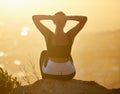 Relax, sunset and fitness woman on a mountain rock looking at nature view for calm yoga. Workout, zen and back of a