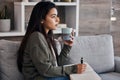 Relax, thinking and woman journaling with coffee for self care on the living room sofa of her house. Idea, tea and girl Royalty Free Stock Photo