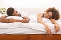 Happily tired african lover resting on bed together